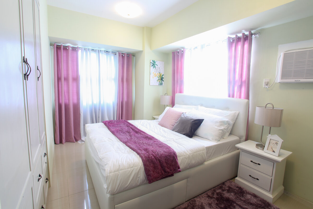 Spacious master bedroom at Horizon View Condo with comfortable queen bed and city views from 37th floor in Cebu