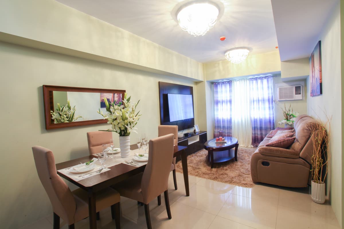 Open concept living area with elegant dining table and city views